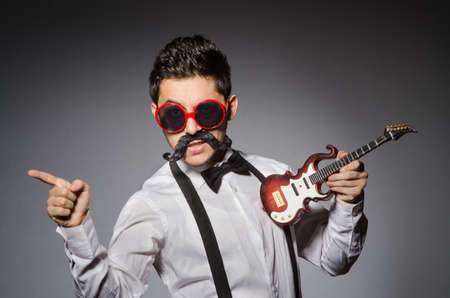 Funny man with mini guitarの写真素材