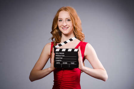 Woman in red dress with movie boardの写真素材