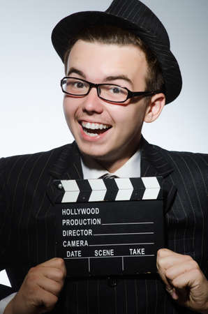Man with movie clapperboard and hatの写真素材