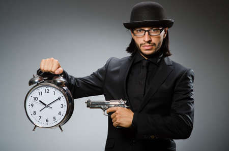 Man with clock wearing vintage hatの写真素材
