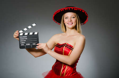 Funny mexican woman with sombrero and movie clapboard