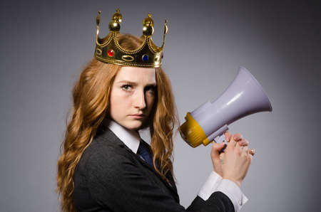 Queen businessman with loudspeaker in funny conceptの写真素材