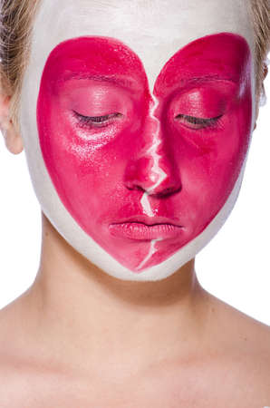 Woman with heart face painting isolated on whiteの写真素材