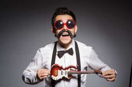 Funny man with mini guitarの写真素材