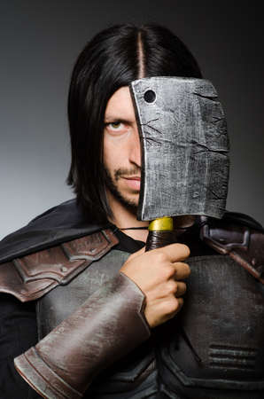 Knight with axe against dark background