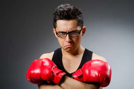 Funny boxer with red gloves against dark backgroundの写真素材