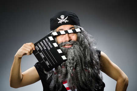 Old pirate with movie boardの写真素材