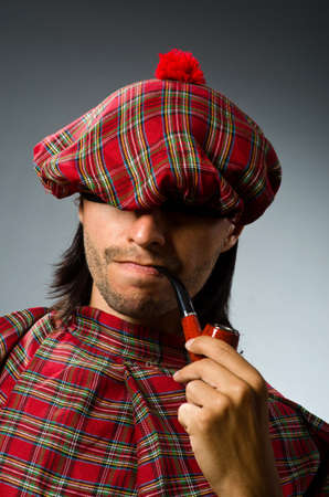 Funny scotsman with smoking pipeの写真素材