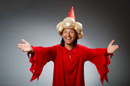Funny wizard wearing red dressの写真素材