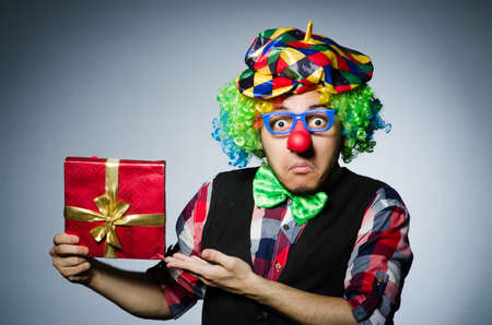 Funny clown with red giftboxの写真素材