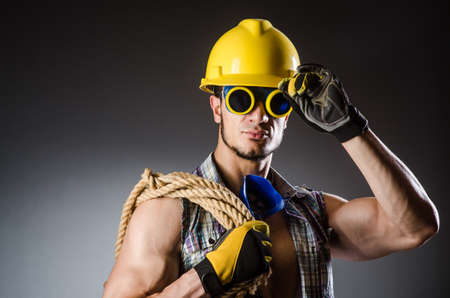 Ripped muscular builder man with toolsの写真素材