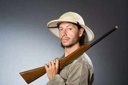 Funny safari hunter with rifleの写真素材