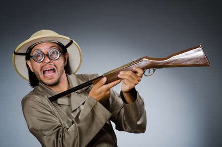 Funny safari hunter with rifleの写真素材