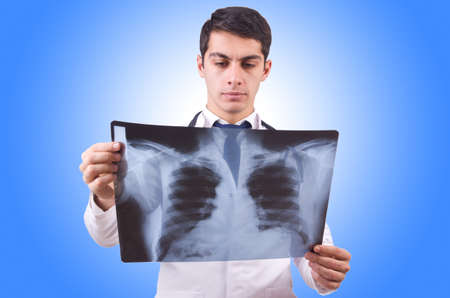 Young doctor with x-ray image on white