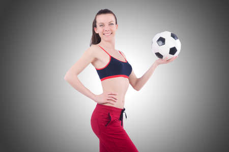 Young woman with football on whiteの写真素材