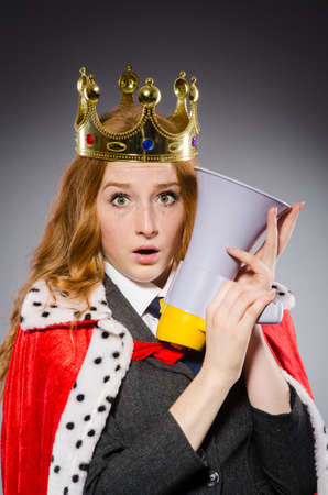 Queen businessman with loudspeaker in funny conceptの写真素材