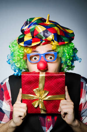Funny clown with red giftboxの写真素材
