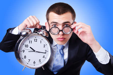 Businessman with clock isolated on whiteの写真素材