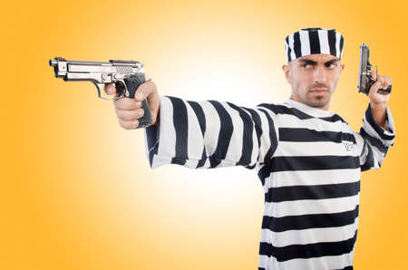 Prisoner with gun isolated on whiteの写真素材