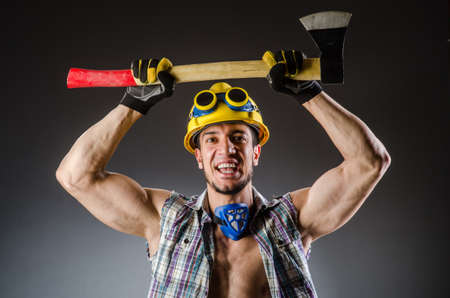 Ripped muscular builder man with toolsの写真素材