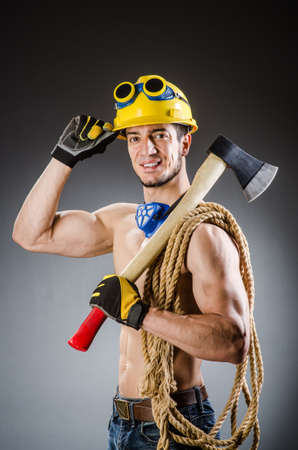 Ripped muscular builder man with toolsの写真素材