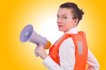 Young woman with vest and loudspeaker on whiteの写真素材