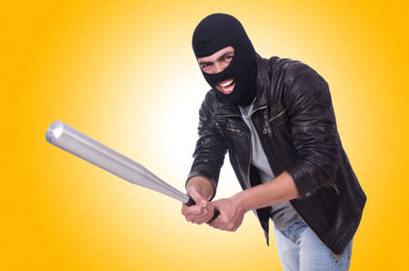 Male hooligan with bat on whiteの写真素材