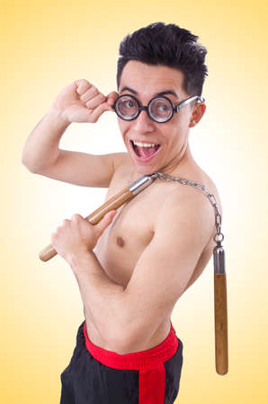 Funny guy with nunchucks on whiteの写真素材