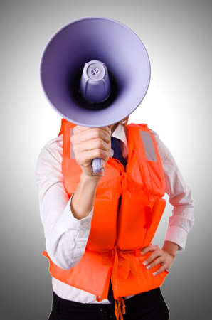 Young woman with vest and loudspeaker on whiteの写真素材