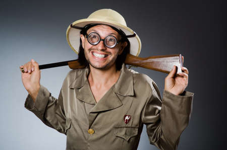Funny safari hunter with rifleの写真素材