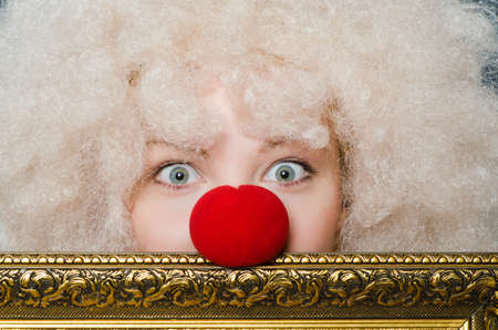 Funny clown with picture frameの写真素材