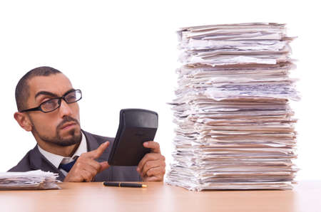 Angry businessman with stack of papersの写真素材