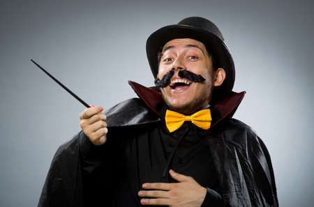 Funny magician man with wand and hatの写真素材