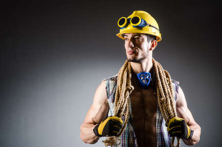 Ripped muscular builder man with toolsの写真素材