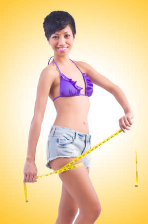 Woman in bikini in diet concept isolated on whiteの写真素材