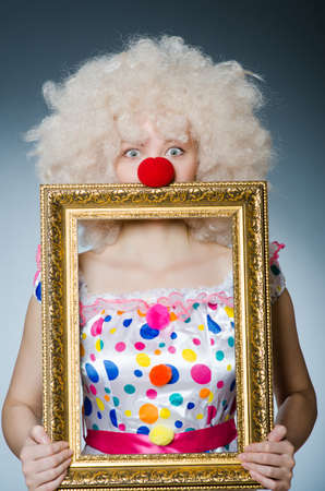 Funny clown with picture frameの写真素材