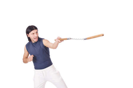 Funny karate fighter with nunchucks on whiteの写真素材