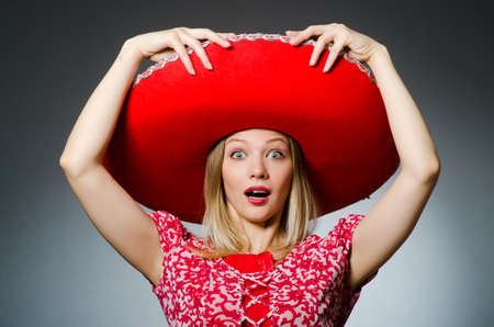 Woman wearing sombrero hat in funny conceptの写真素材