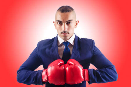 Handsome businessman with boxing glovesの写真素材