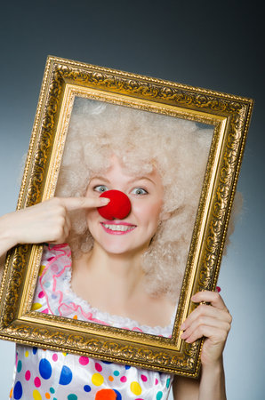 Funny clown with picture frameの写真素材