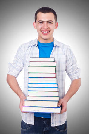 Student with lots of books on whiteの写真素材