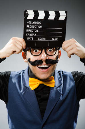 Funny man holding movie clapperの写真素材