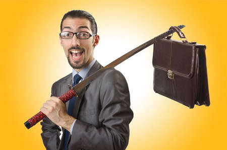 Businessman with sword on whiteの写真素材