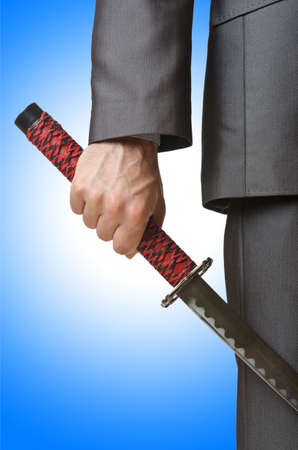 Businessman with sword on whiteの写真素材