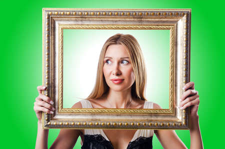 Woman with picture frames on white
