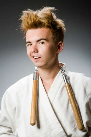 Funny karate fighter with nunchucksの写真素材