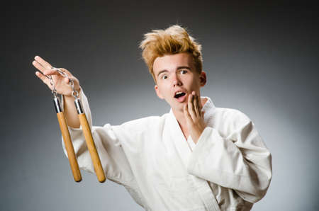 Funny karate fighter with nunchucksの写真素材