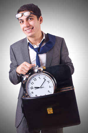Businessman with clock isolated on whiteの写真素材