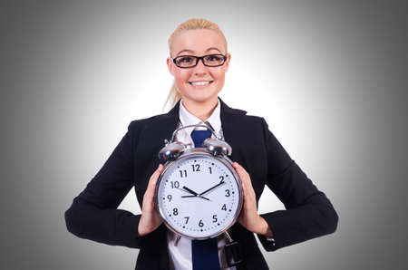 Woman with giant clock on whiteの写真素材