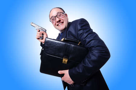 Businessman with gun isolated on whiteの写真素材